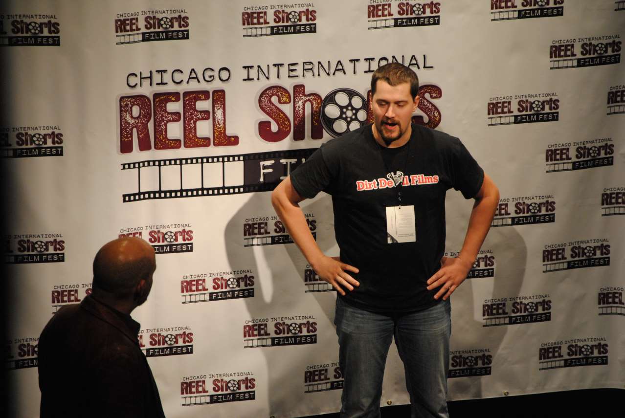 Man with hands on hips speaks at a Chicago film festival.