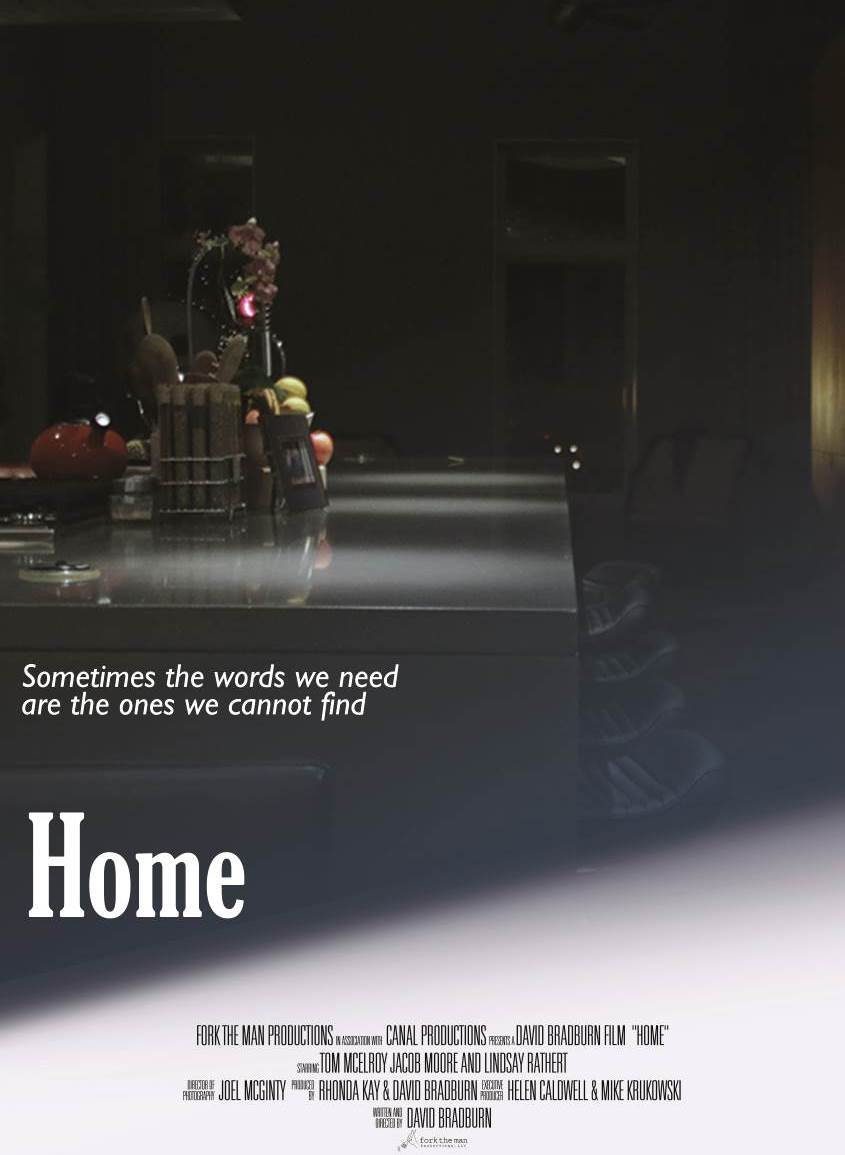Dark stage with props in the back, bright spotlight on the empty floor.