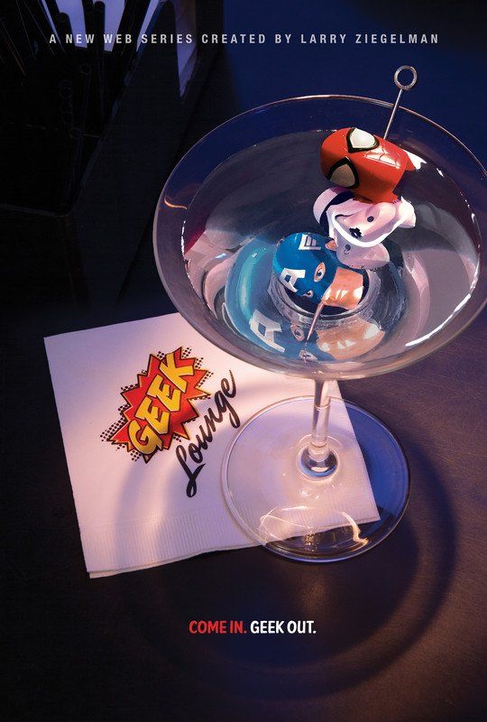 Martini glass with superhero helmets on a Geek Lounge napkin.