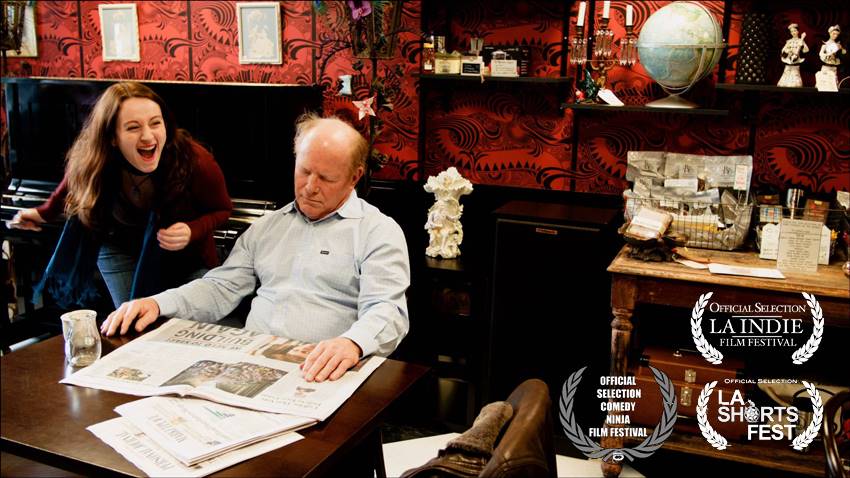 Woman screams at man reading newspaper in a dark, cluttered room. Film festival laurels.