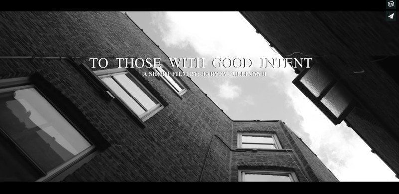 A black and white photo of buildings, with the text