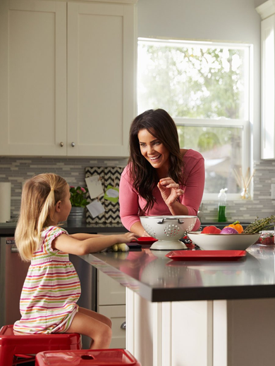 grandma playing with her grand daughter in the kitchen
