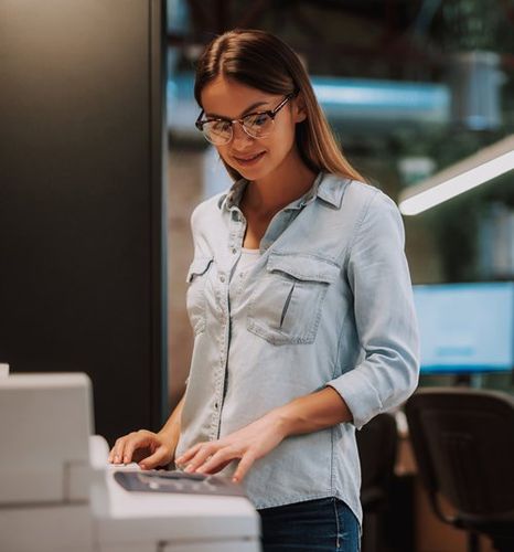 Woman Standing Near Photocopier — Miami, FL — Best Office Systems International Corporation Woman Standing Near Photocopier — Miami, FL — Best Office Systems International Corporation