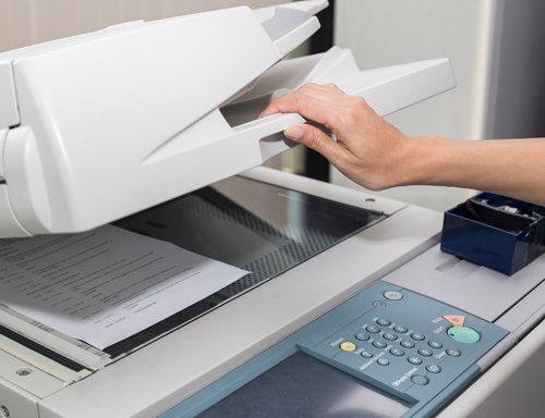 Woman Opening a Photocopier — Miami, FL — Best Office Systems International Corporation Woman Opening a Photocopier — Miami, FL — Best Office Systems International Corporation