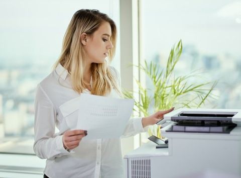 Businesswoman Prints on The Printer — Miami, FL — Best Office Systems International Corporation Businesswoman Prints on The Printer — Miami, FL — Best Office Systems International Corporation