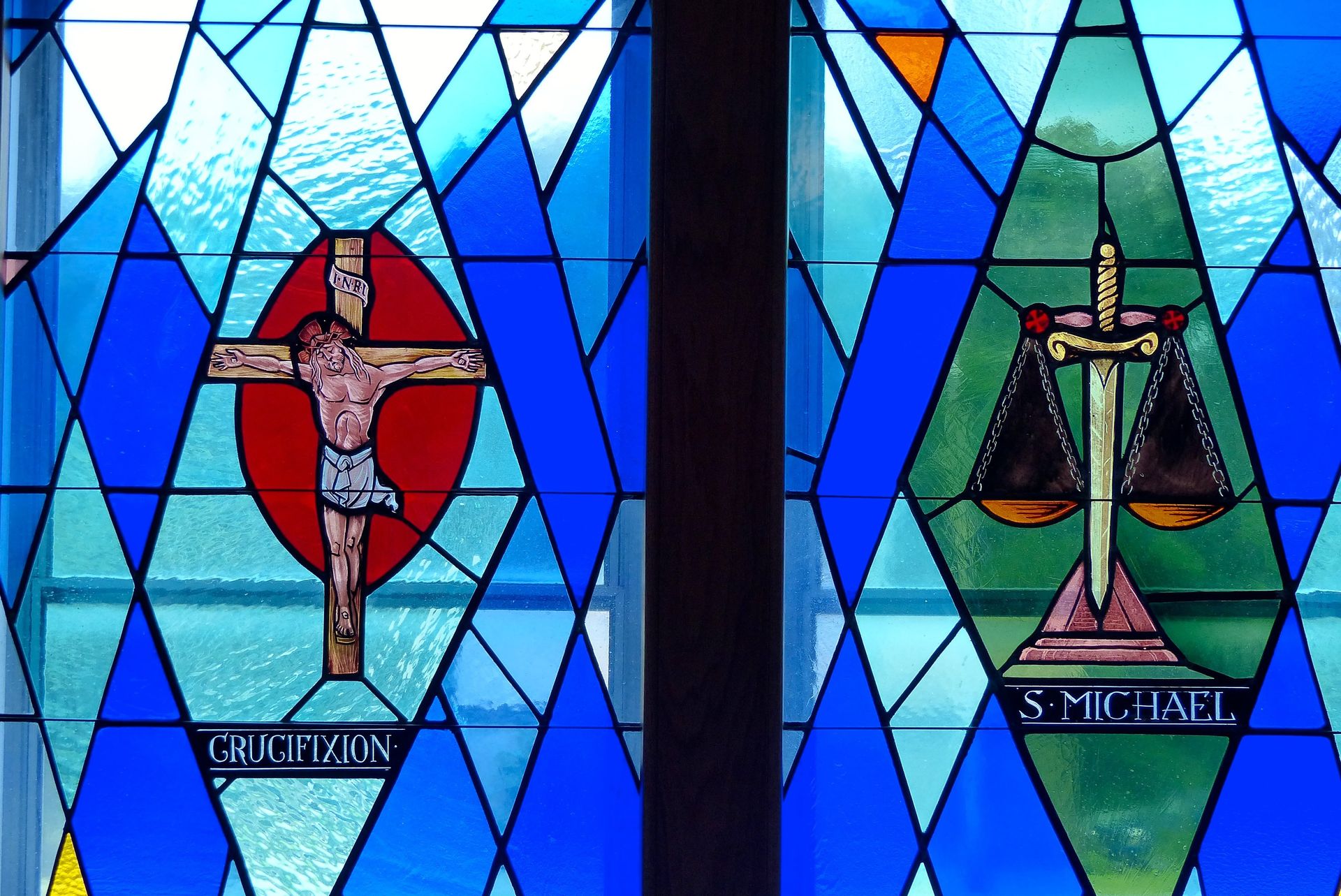 Stained glass windows: crucifixion and scales of justice, blue diamond border. 