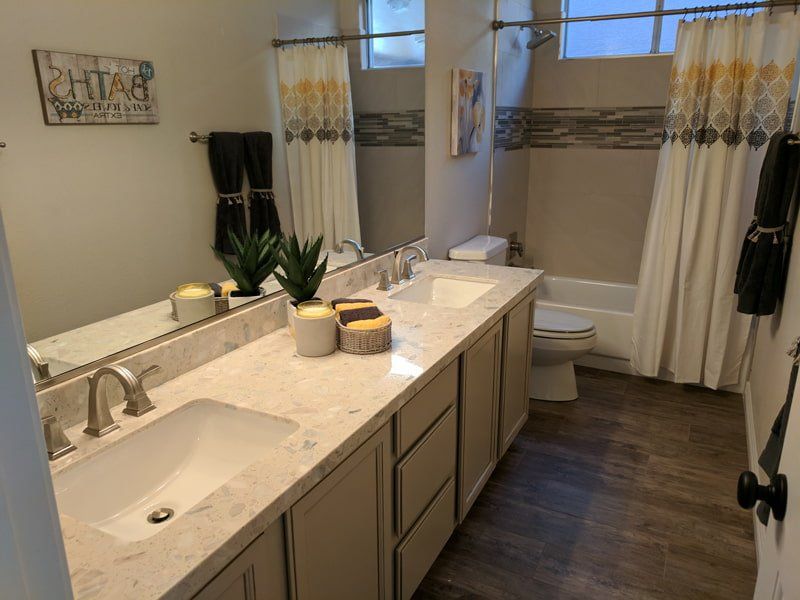 white granite counter top with two sinks in bathroom