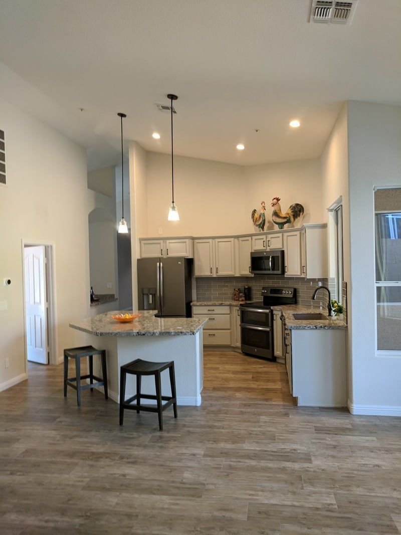picture of open kitchen with angular island and hanging lights