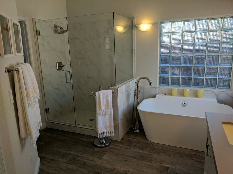 bath tub next to walk in shower in bathroom