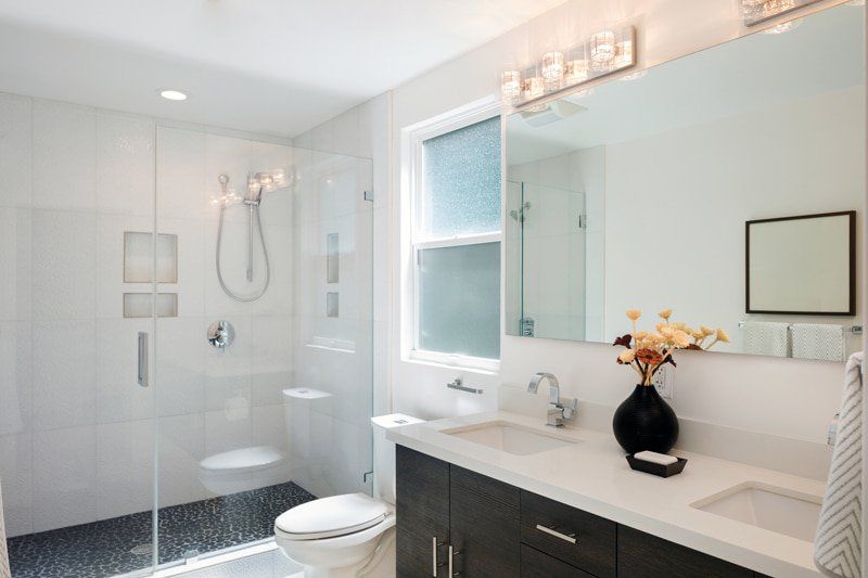 bathroom with walk in shower next to toilet