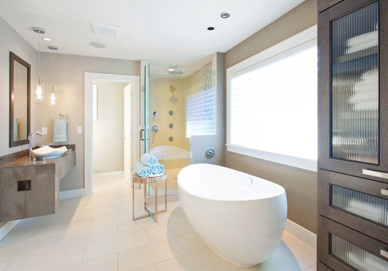 egg shaped bathtub in bathroom with floating counter