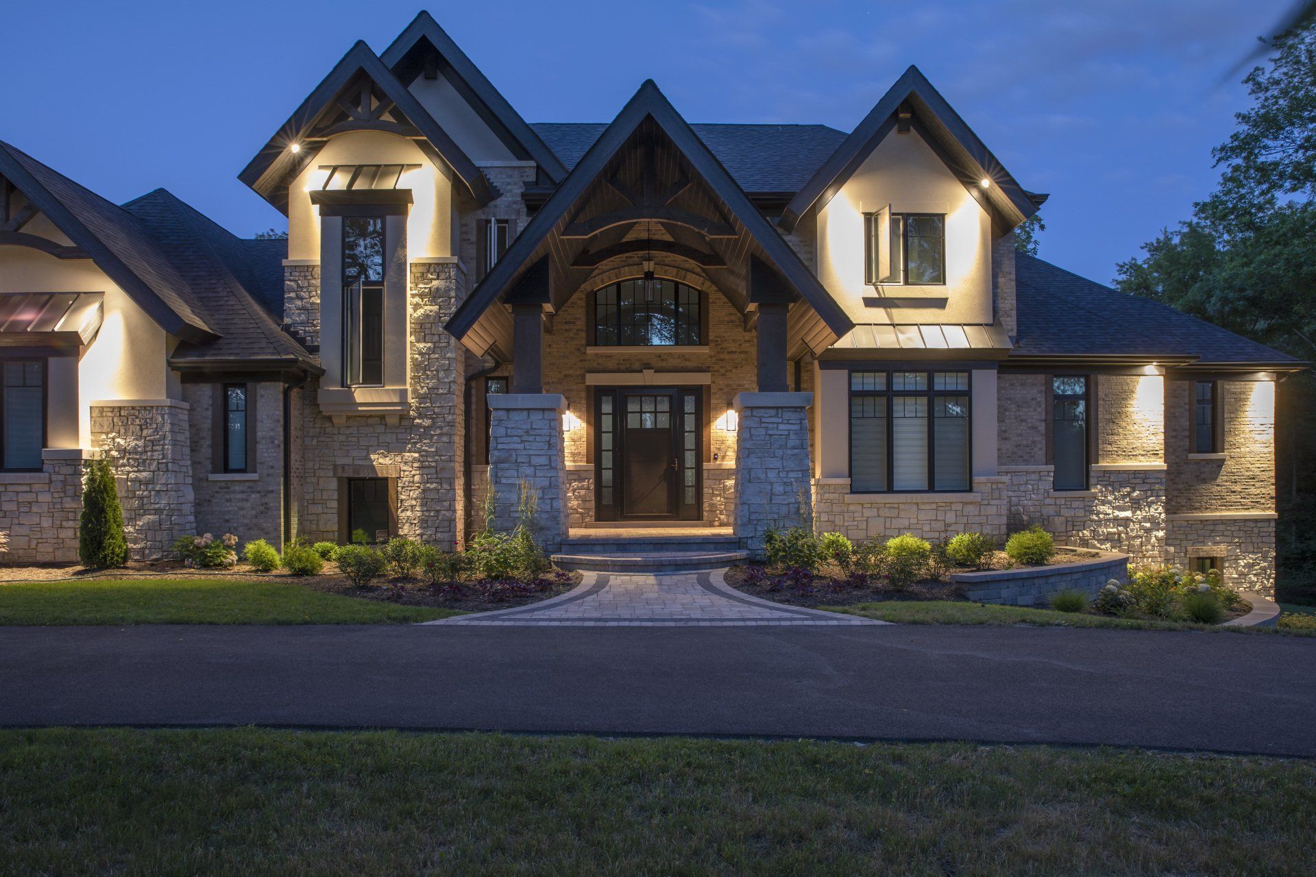 A large house with a lot of windows is lit up at night.