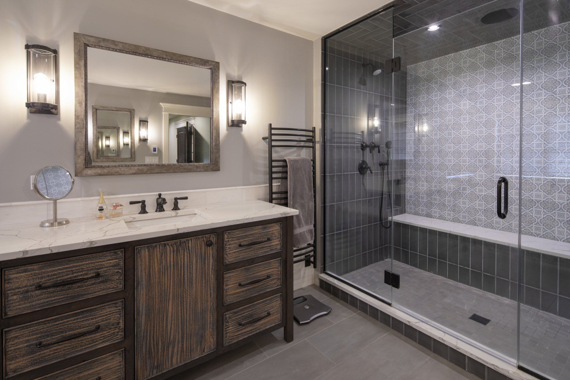 A bathroom with a walk in shower , sink and mirror.