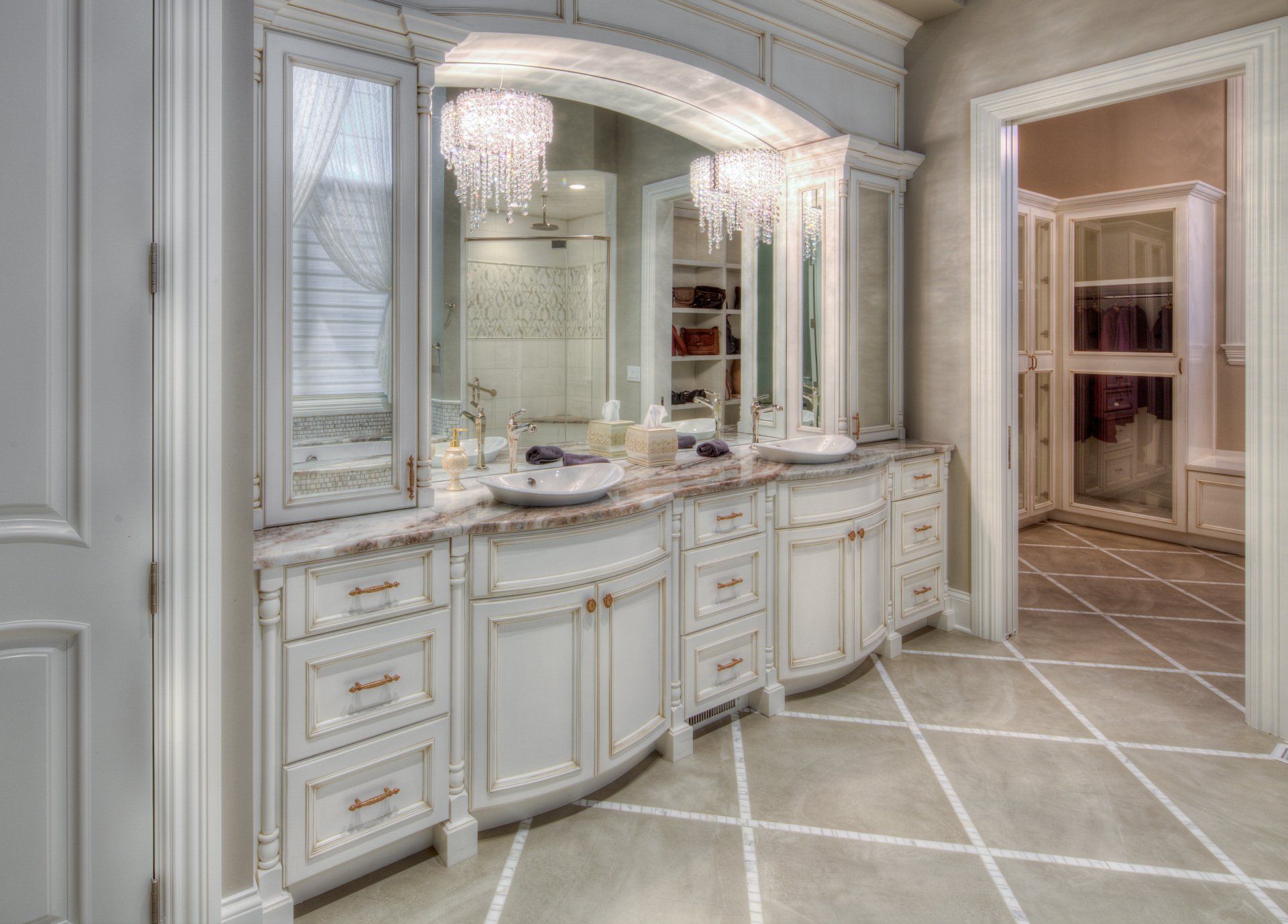 A bathroom with two sinks , a large mirror , and a walk in closet.