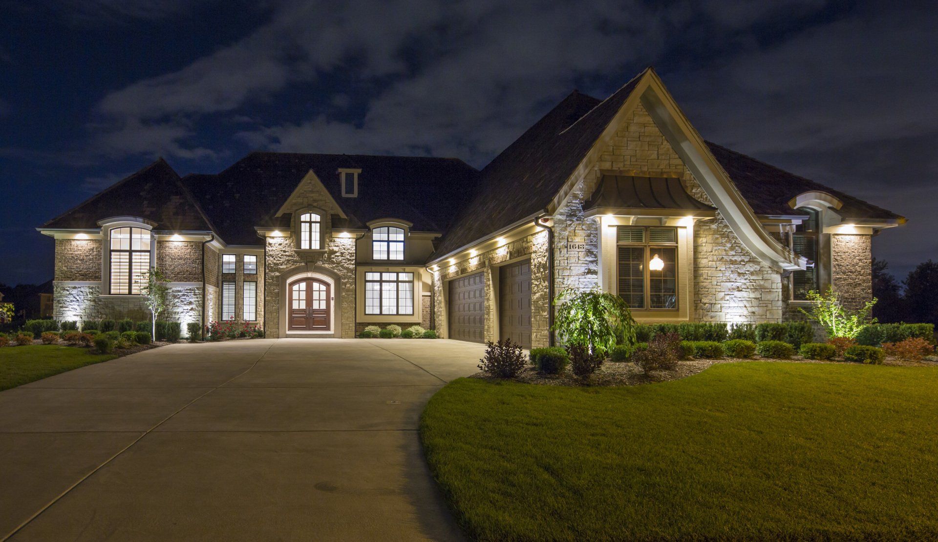 A large house is lit up at night.
