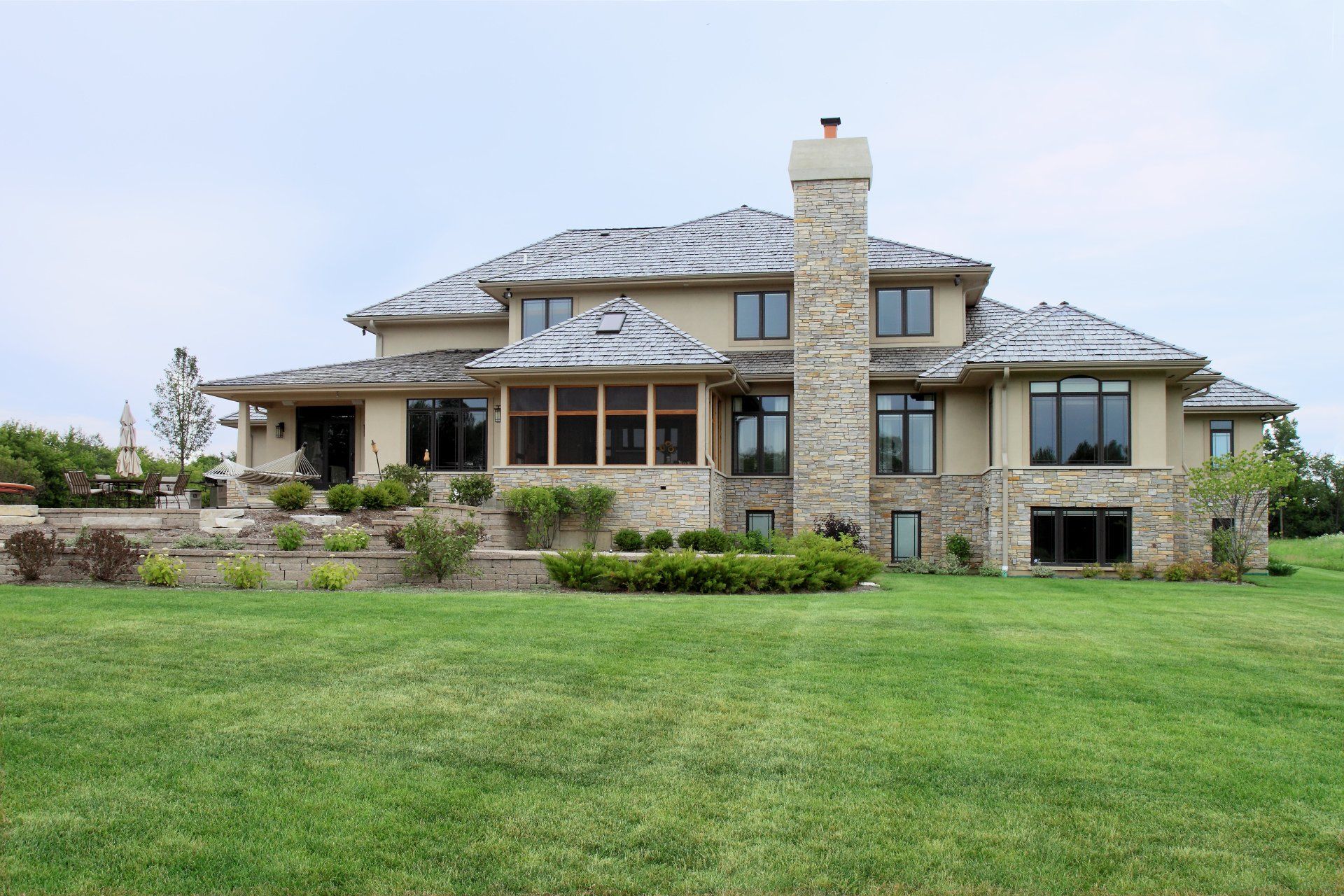 A large house with a lot of windows and a chimney
