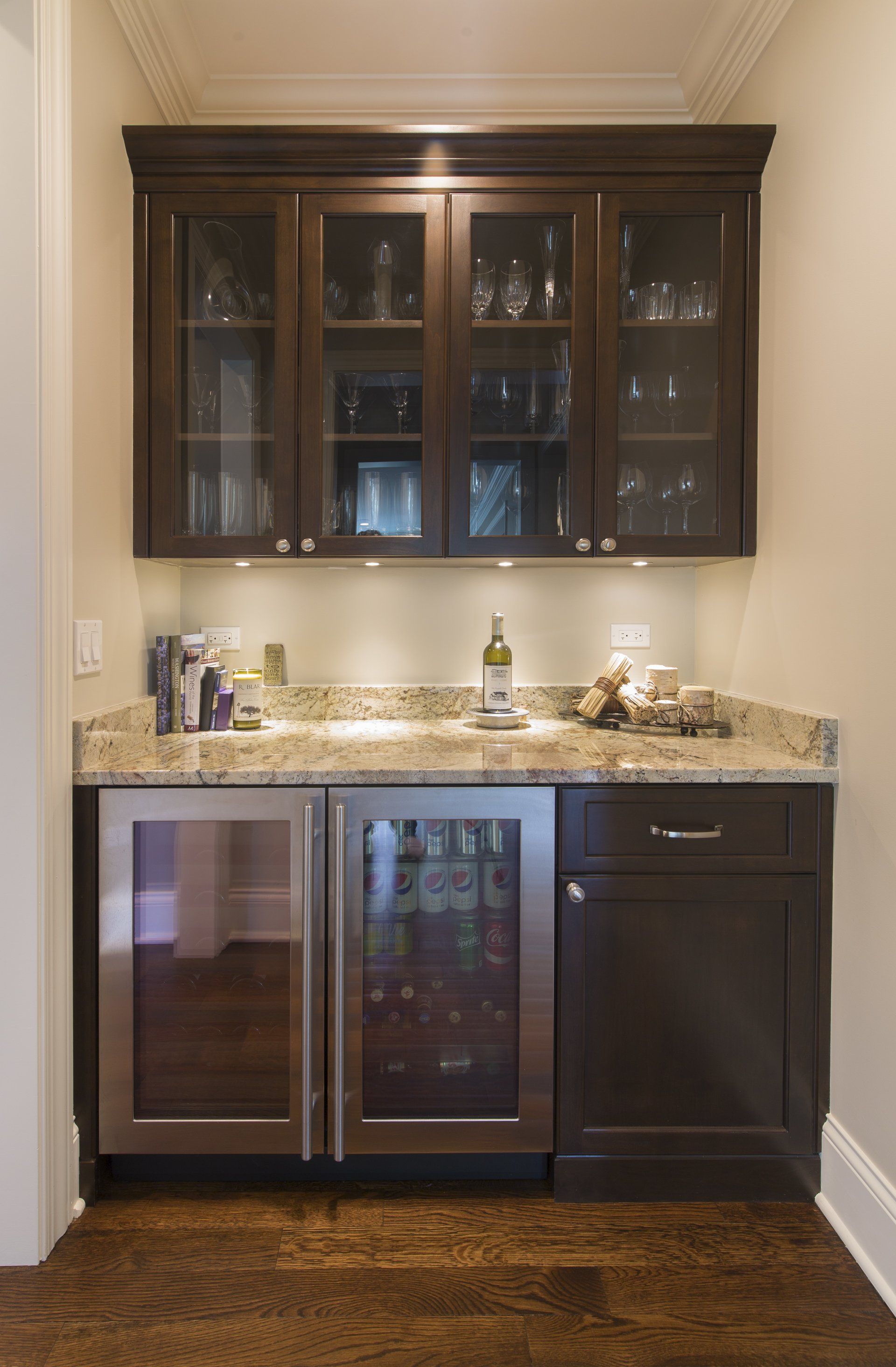 A small kitchen with stainless steel cabinets and a wine cooler.