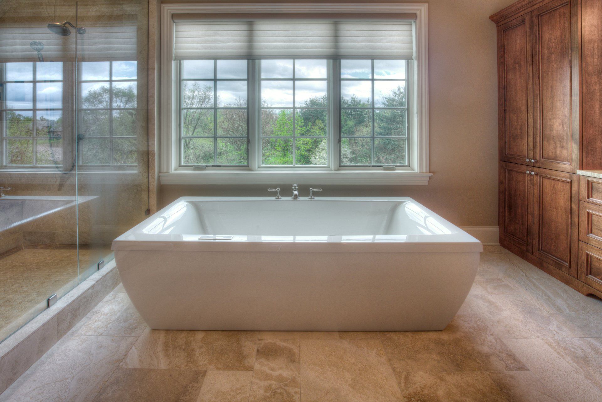 There is a large bathtub in the middle of the bathroom.