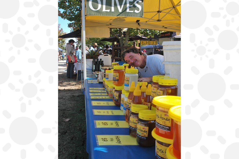 man smiling in his olives stall