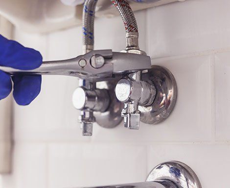 Plumber Holding Wrench — Martinez, CA — Ernie’s Plumbing & Sewer Service Plumber Holding Wrench — Martinez, CA — Ernie’s Plumbing & Sewer Service