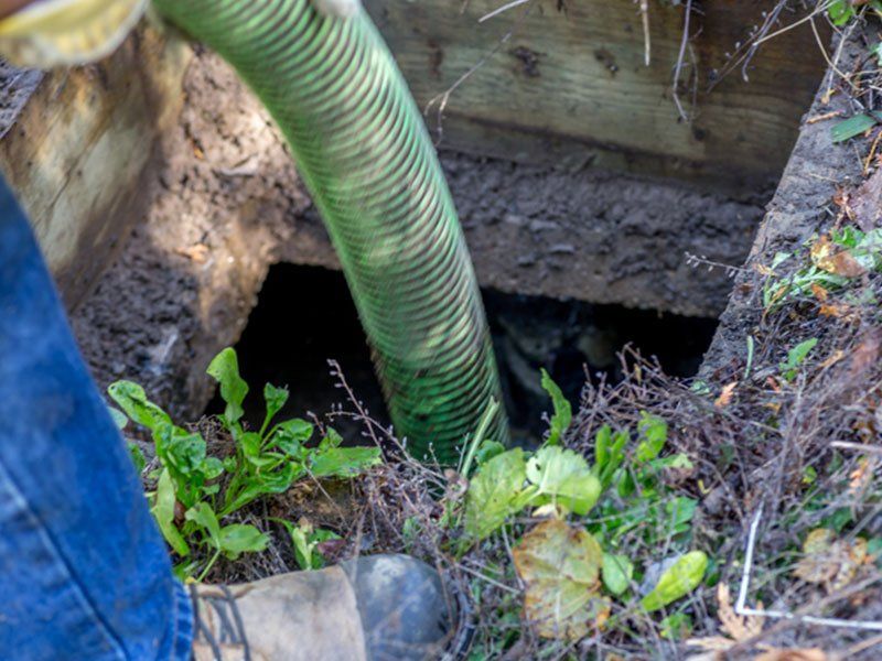 Worker Emptying Septic — Martinez, CA — Ernie’s Plumbing & Sewer Service Worker Emptying Septic — Martinez, CA — Ernie’s Plumbing & Sewer Service
