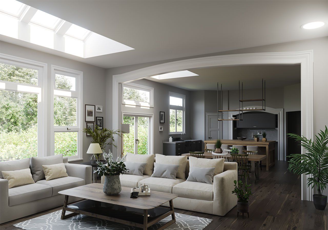 A living room with a couch , coffee table , and lots of windows.