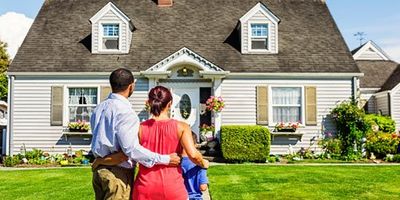 family in front of house