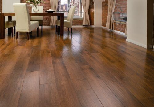 A green sofa on laminate flooring