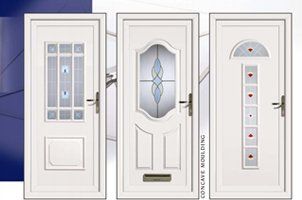Three white decorative front doors with glass inserts and varied panel designs displayed side by side