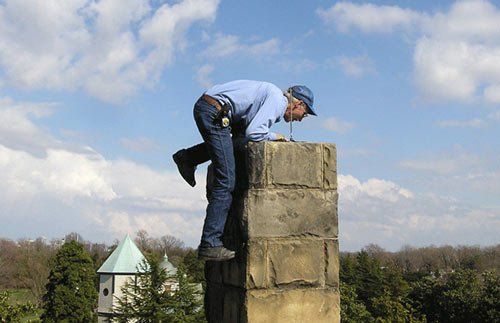 Worker inspecting inside of chimney -chimney relining in Ruther Glen, VA Worker inspecting inside of chimney -chimney relining in Ruther Glen, VA