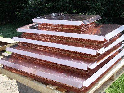 Stack of copper heat exchangers with honeycomb cores, outdoors.