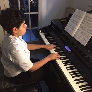 boy playing piano