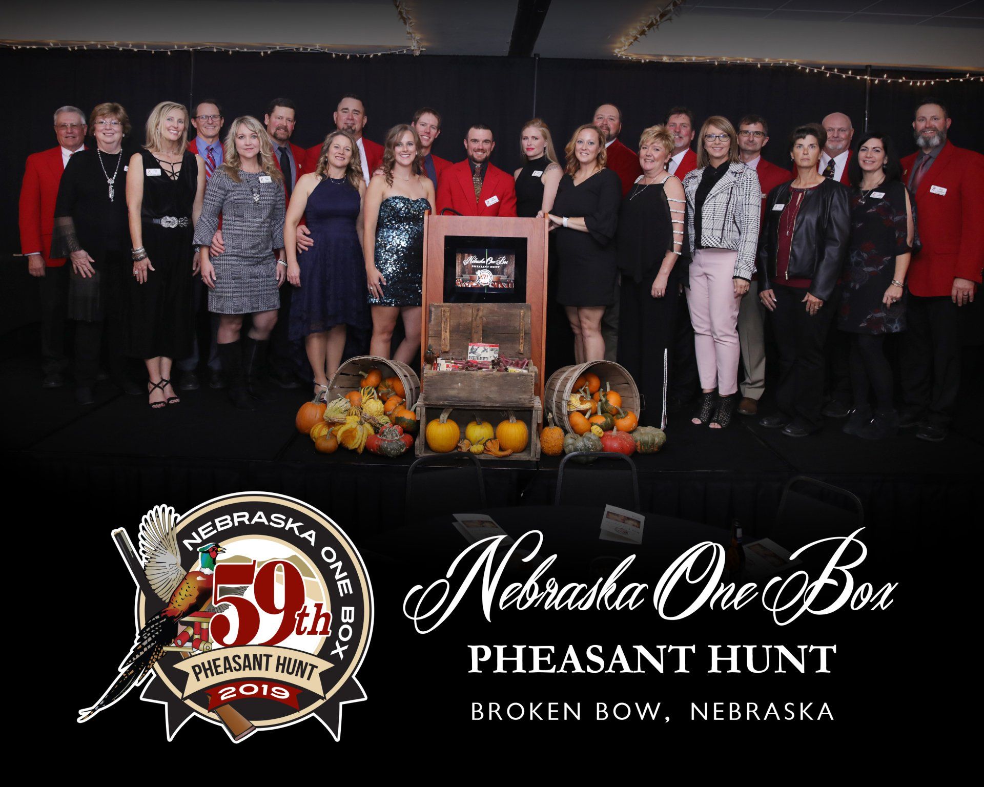 Group photo at the 59th Nebraska One Box Pheasant Hunt in Broken Bow. Attendees in formal wear.