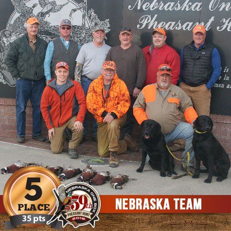 Group of hunters and dogs pose with pheasant, labeled as 