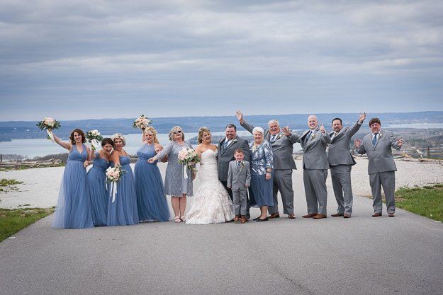 the bride and groom are posing for a picture with their wedding party .