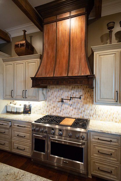 a kitchen with stainless steel appliances and white cabinets