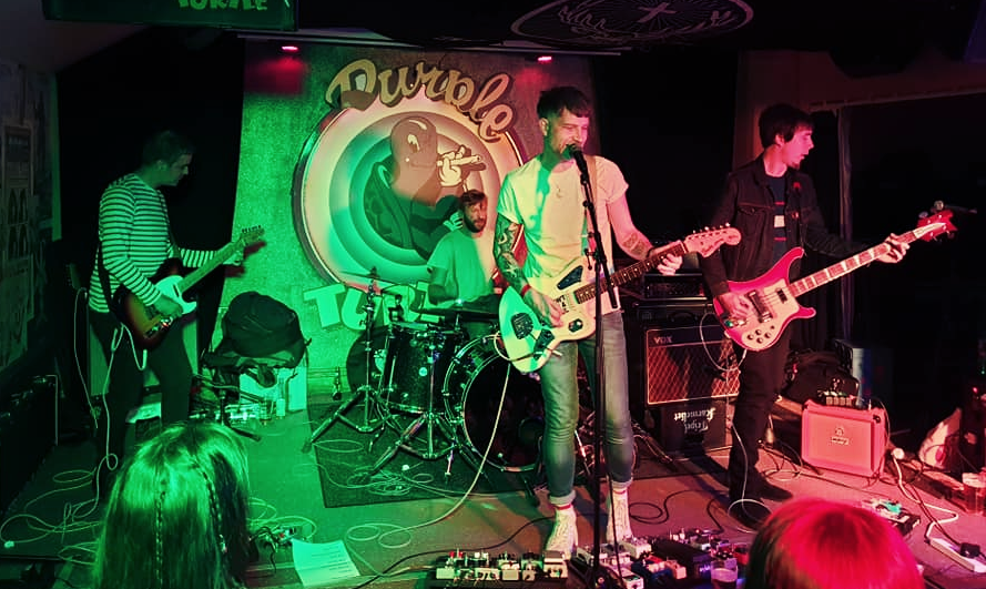 A group of people are playing instruments on a stage.