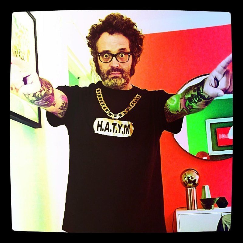 A man wearing a shirt that says h.a.t.y.m