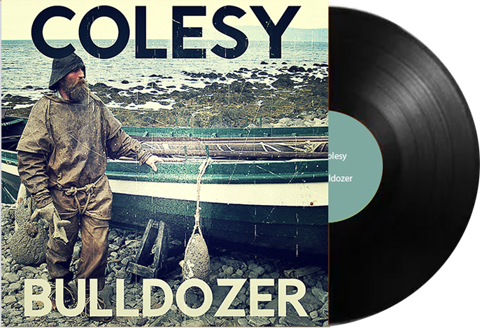 A man standing next to a boat on the cover of colesy bulldogzer