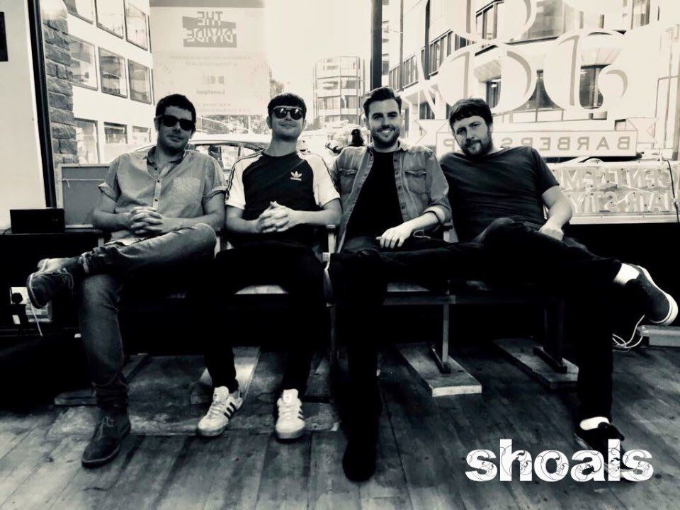 A group of men are posing for a picture in a black and white photo.