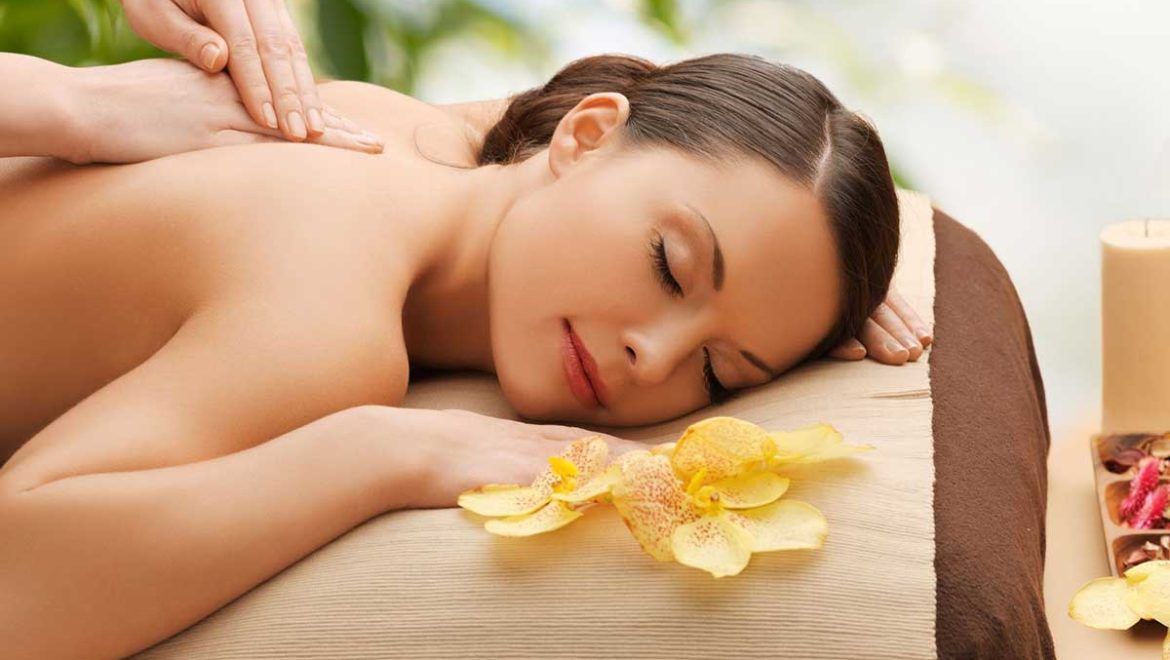 Relaxing Osteophatetic Massage Girl With Flowers Beside