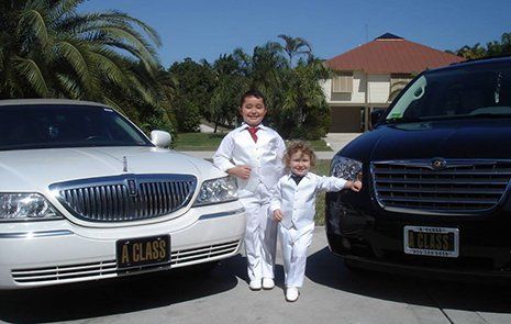 Two Kids Infront Of Limousine — Marco Island, FL — A Class Transportation Two Kids Infront Of Limousine — Marco Island, FL — A Class Transportation