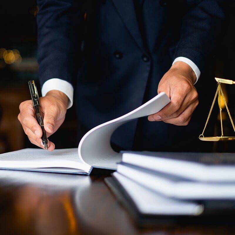 Lawyer writing notes— Anderson Telford Lawyers in Townsville, QLD
