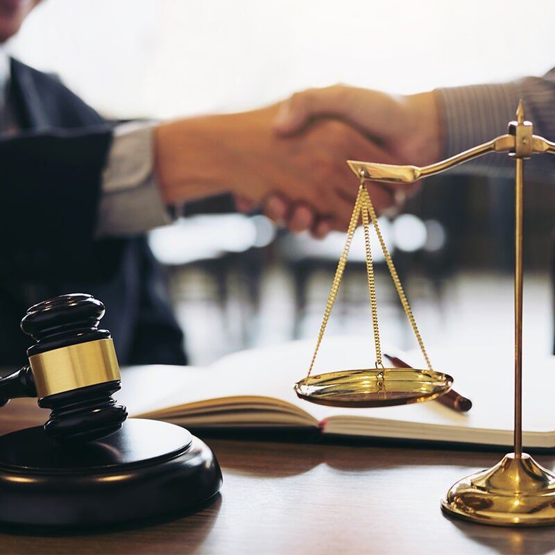 Lawyer and Clients Handshake Deal — Anderson Telford Lawyers in Townsville, QLD