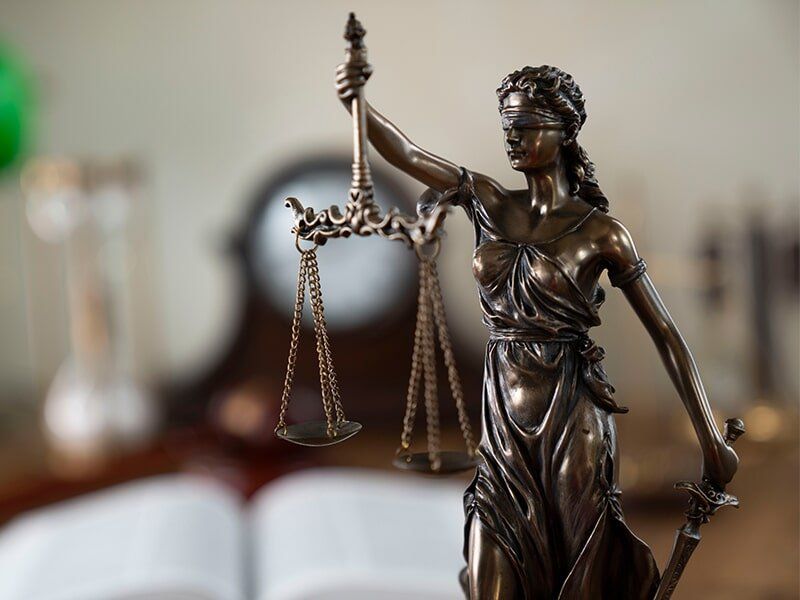 scales of justice being held by lady justice scales of justice being held by lady justice