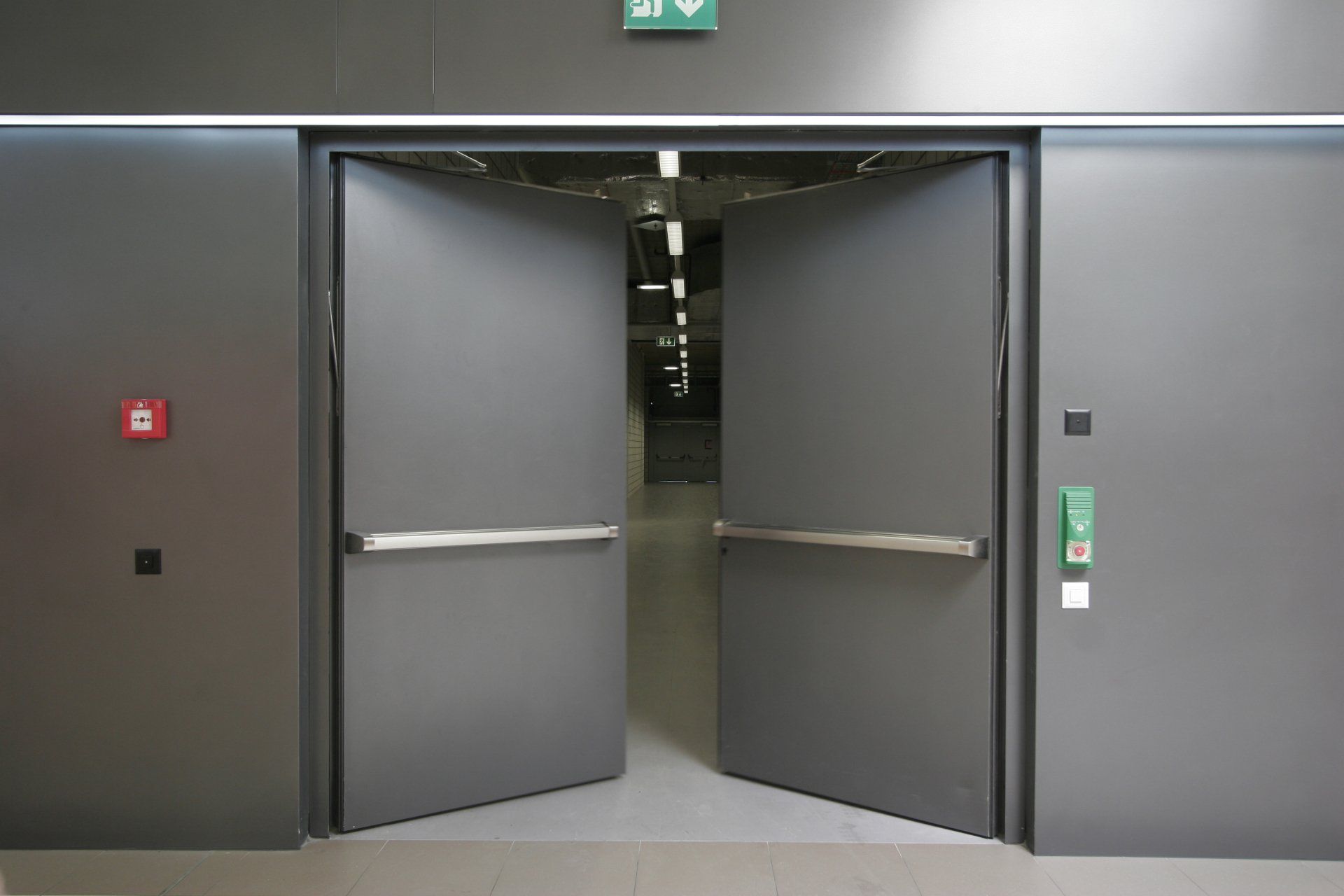 A pair of metal doors that are open in a building.