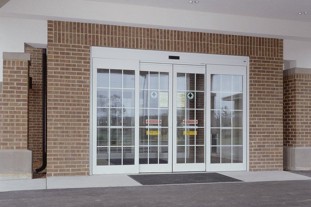 A brick building with a sliding glass door