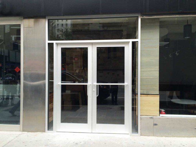 A building with a double door and a stainless steel frame.