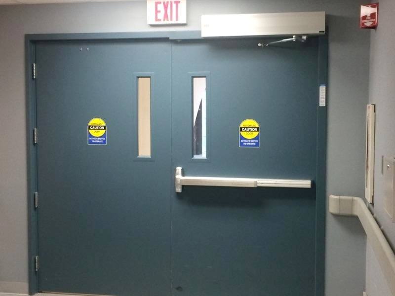A blue door with a red exit sign above it