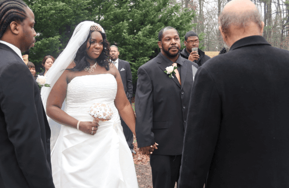 A bride and groom are walking down the aisle at their wedding